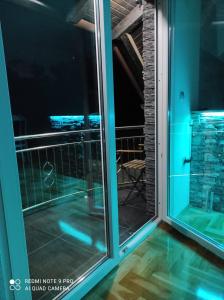 an open door to a balcony with a view of the ocean at Apartman-vikendica Mihajlović in Banja Luka +24 photos
