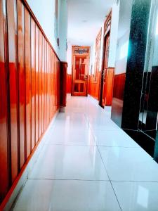 a hallway of a building with a door and a tile floor at Thien Truong Hotel in Nha Trang