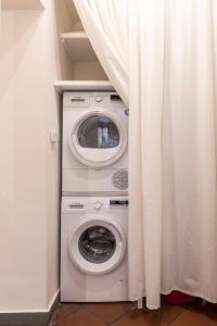 a washer and dryer in a room with a curtain at Casa Dora in Florence
