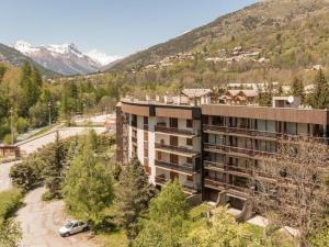 an aerial view of a building with mountains in the background at Appartement Saint-Chaffrey , 2 pièces, 6 personnes - FR-1-330E-32 in Saint-Chaffrey