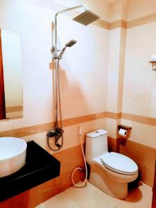 a bathroom with a toilet and a sink and a shower at Thien Truong Hotel in Nha Trang
