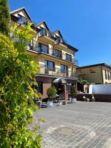 a building with a patio in front of it at Willa Klif &Spa in Jastrzębia Góra