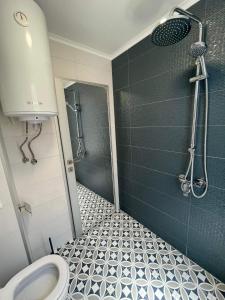 a bathroom with a shower and a toilet at Chernomorets Apartment in Chernomorets