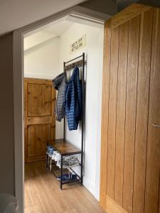 a room with a closet with a wooden door at Moll’n’Cliff in Silsden