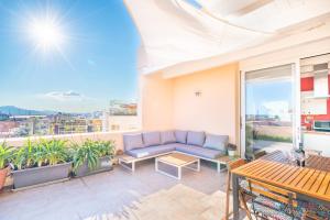 a living room with a couch on a balcony at Attico Luce e Colori - Terrazza Vista Mare - 5 Bdr in Cagliari