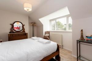 a bedroom with a bed and a mirror and a window at Pine Park in Ushaw Moor