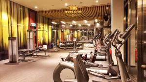 a gym with a row of treadmills at Crown Suites Tropicana The Residence KLCC Bukit Bintang Kuala Lumpur in Kuala Lumpur