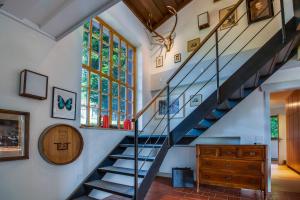 a winding staircase in a home with a window at Künstlervilla mit grandiosem Panoramablick in Fischbachau