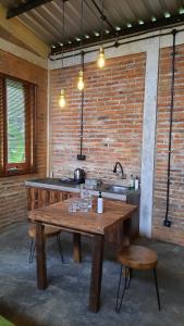 a kitchen with a wooden table and a sink at RUMAH @ Sawah Ijen in Licin