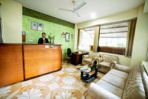 a man standing at a bar in a living room at Hotel Peace Stupa in Pokhara
