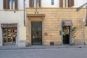 a brick building with two store fronts with windows at Casa Dora in Florence