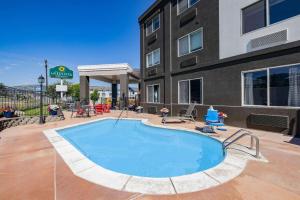 a large swimming pool in front of a building at La Quinta by Wyndham Helena in Helena