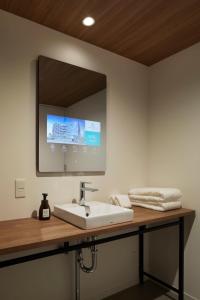 a bathroom with a sink and a mirror at Prince Smart Inn Ebisu in Tokyo