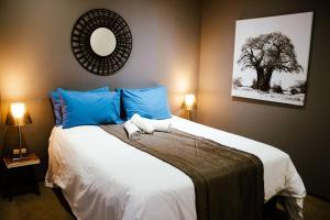 a bedroom with a large bed with blue pillows at Luxury Condo-loft Point Waterfront - Two bedroom plus Loft in Durban