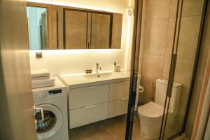 a bathroom with a sink and a washing machine at Urban Apartments in Komotini
