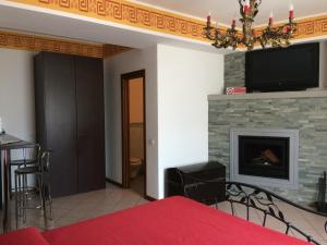 a living room with a fireplace and a tv at Casa Martina in Zogno