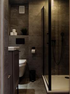 a bathroom with a shower and a toilet at Downtown friendly studio in Bucharest