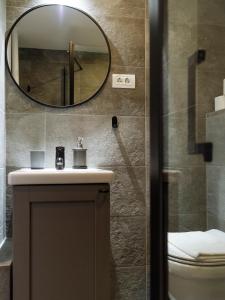 a bathroom with a sink and a mirror at Downtown friendly studio in Bucharest