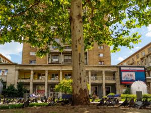 a building with a tree in front of it at Downtown friendly studio in Bucharest