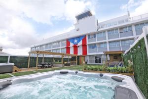 a large building with a hot tub in front of it at San Juan Airport Hotel in San Juan