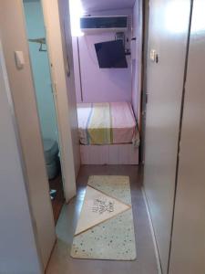 Habitación pequeña con cama y cartel en el suelo en Luxury family caravan truck in the Golan Heights, en Bruchim Qela' Alon