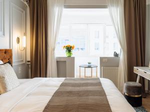 a bedroom with a large bed and a window at Elegant Cosy Studio - Calea Victoriei in Bucharest