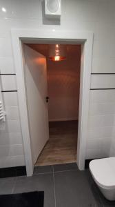 a hallway with a toilet in a bathroom at SLASKA 12 in Gdańsk