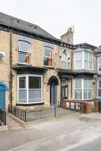 a brick house with people in the windows at Vibrant Funkily Decorated 2 Bedroom 4 Beds Central Location in Hull