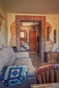 a living room with a couch and a brick wall at Bella Vista in Atena Lucana