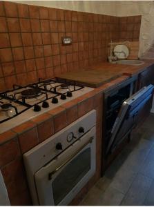 a kitchen with a stove top oven and a sink at Bella Vista in Atena Lucana