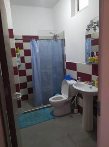 a bathroom with a toilet and a sink at Apartamento T2 em Sal Rei - Boavista in Sal Rei