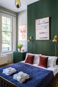 a bedroom with a bed with two towels on it at Sunny Corner Apartment in Center of London (1) in London