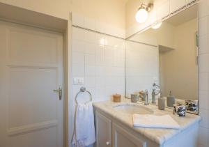 a bathroom with a sink and a mirror at La Dimora di Corte in Lucca