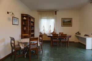 a dining room with a table and chairs and a window at Al Picchio Verde A.P.S. in Cunardo