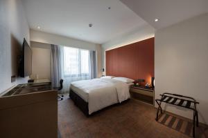 Giường trong phòng chung tại K Hotels Taipei Linsen