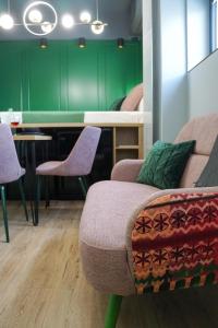 a room with a couch and chairs and a table at Green Sunnyside Studio - Central Location in Bucharest