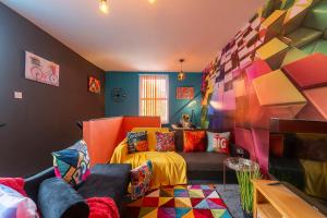 a colorful living room with a couch and a bed at Vibrant Funkily Decorated 2 Bedroom 4 Beds Central Location in Hull