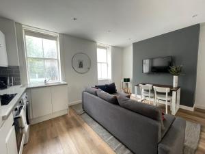 a living room with a couch and a table at Goodge Street Apartments in London