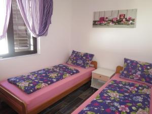 een kamer met 2 bedden en een raam bij Holiday Home Matea by Interhome in Batalaži