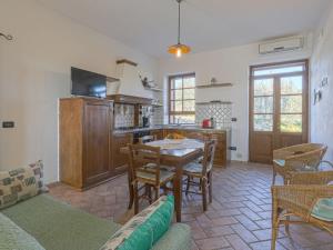 a kitchen with a table and chairs in a room at Holiday Home Cignanbianco - Alba by Interhome in Castellina in Chianti