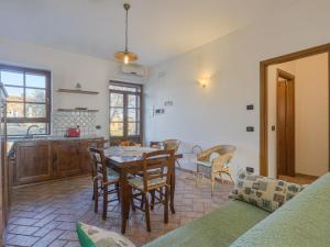 a kitchen and dining room with a table and chairs at Holiday Home Cignanbianco - Alba by Interhome in Castellina in Chianti