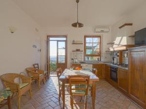 una cocina con mesa, sillas, mesa y mesa en Holiday Home Cignanbianco - Tramonto by Interhome, en Castellina in Chianti