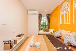 a bedroom with a bed and a couch and a window at Elegant room near beaches, shopping, restaurant​s in Phuket Town +28 photos