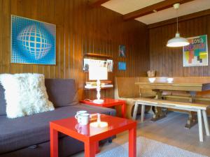 a living room with a couch and a piano at Apartment Entremont 60 by Interhome in Verbier