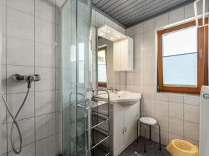 a bathroom with a glass shower and a sink at Apartment Ratgebgut by Interhome in Zell am See