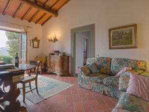 a living room with a couch and a table at Holiday Home Vignole by Interhome in Panzano