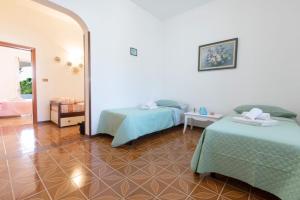 Postel nebo postele na pokoji v ubytování Villetta Goccia D'oro