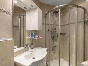 a bathroom with a sink and a shower at Apartment Dachstein-3 by Interhome in Flachau
