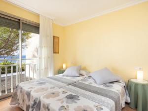 two beds in a bedroom with a balcony at Apartment La Tejita by Interhome in La Tejita