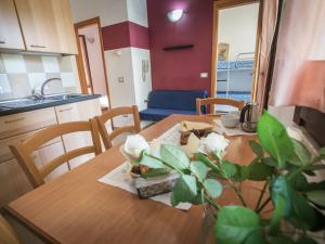 a kitchen and dining room with a wooden table at Holiday Home Miramare-3 by Interhome in Antignano